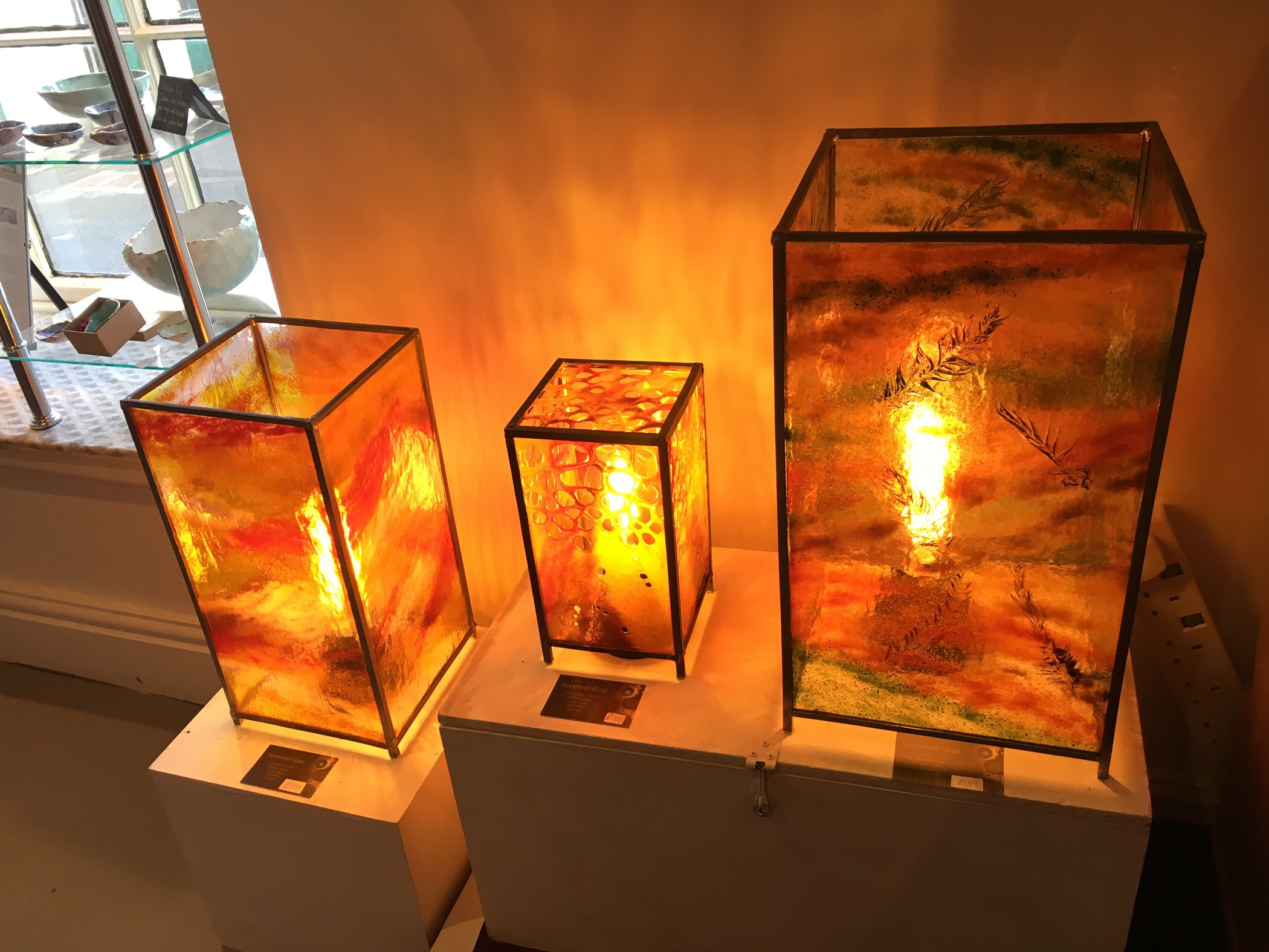 Three sizes of red fused glass electric lamps