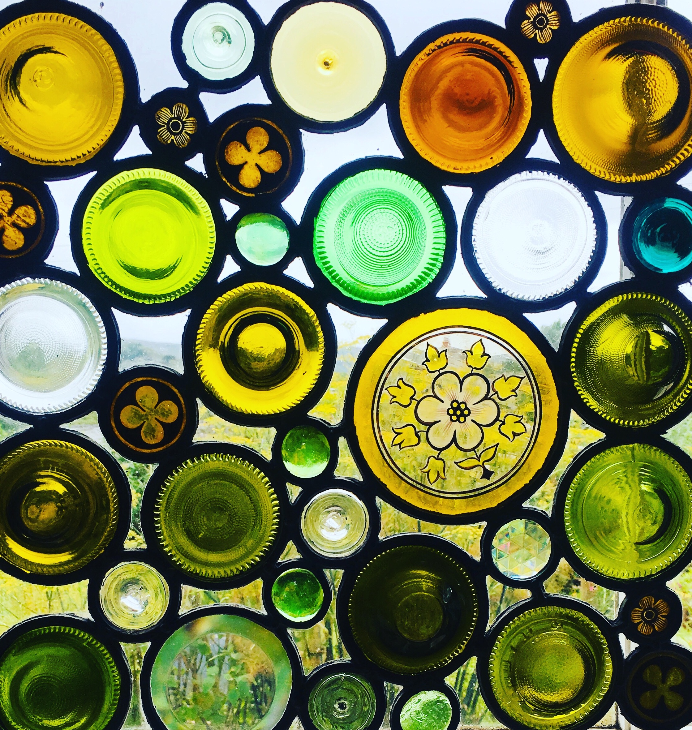 Stained glass window made of reused bottle bases