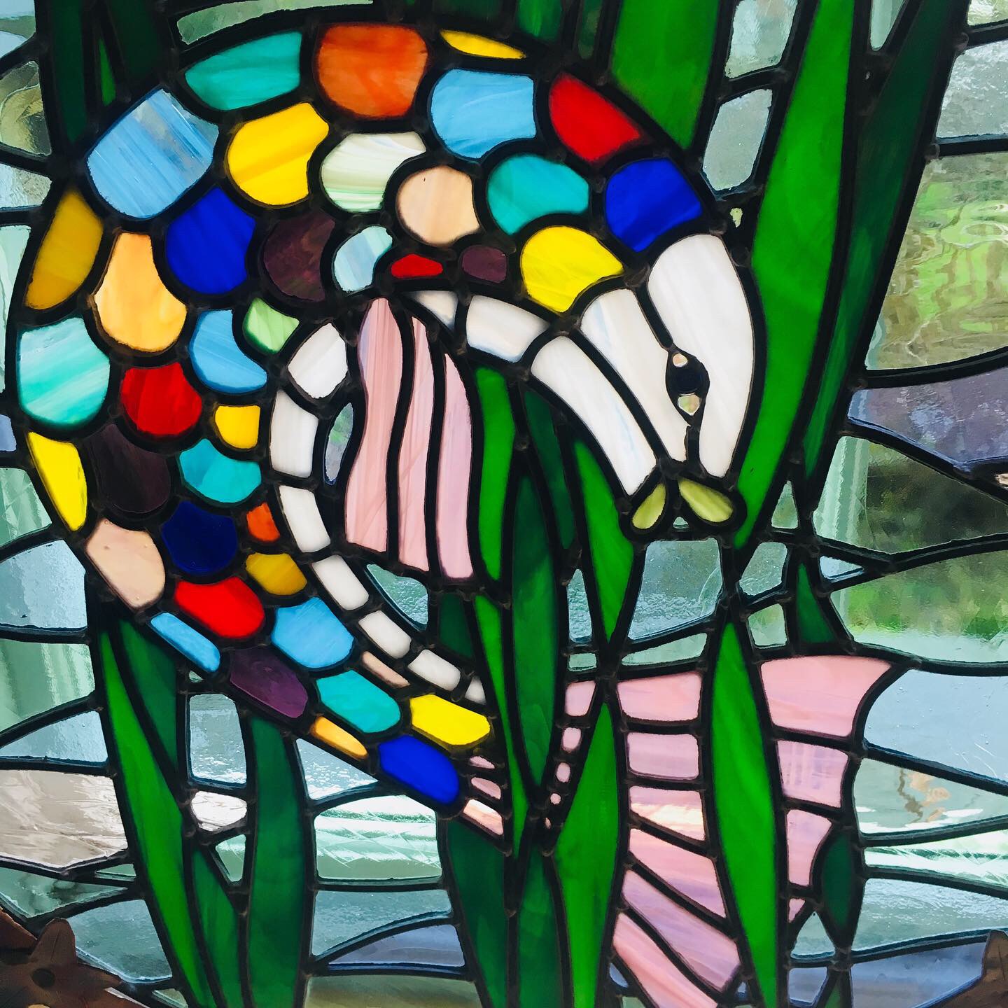Stained glass window depicting a colourful fish
