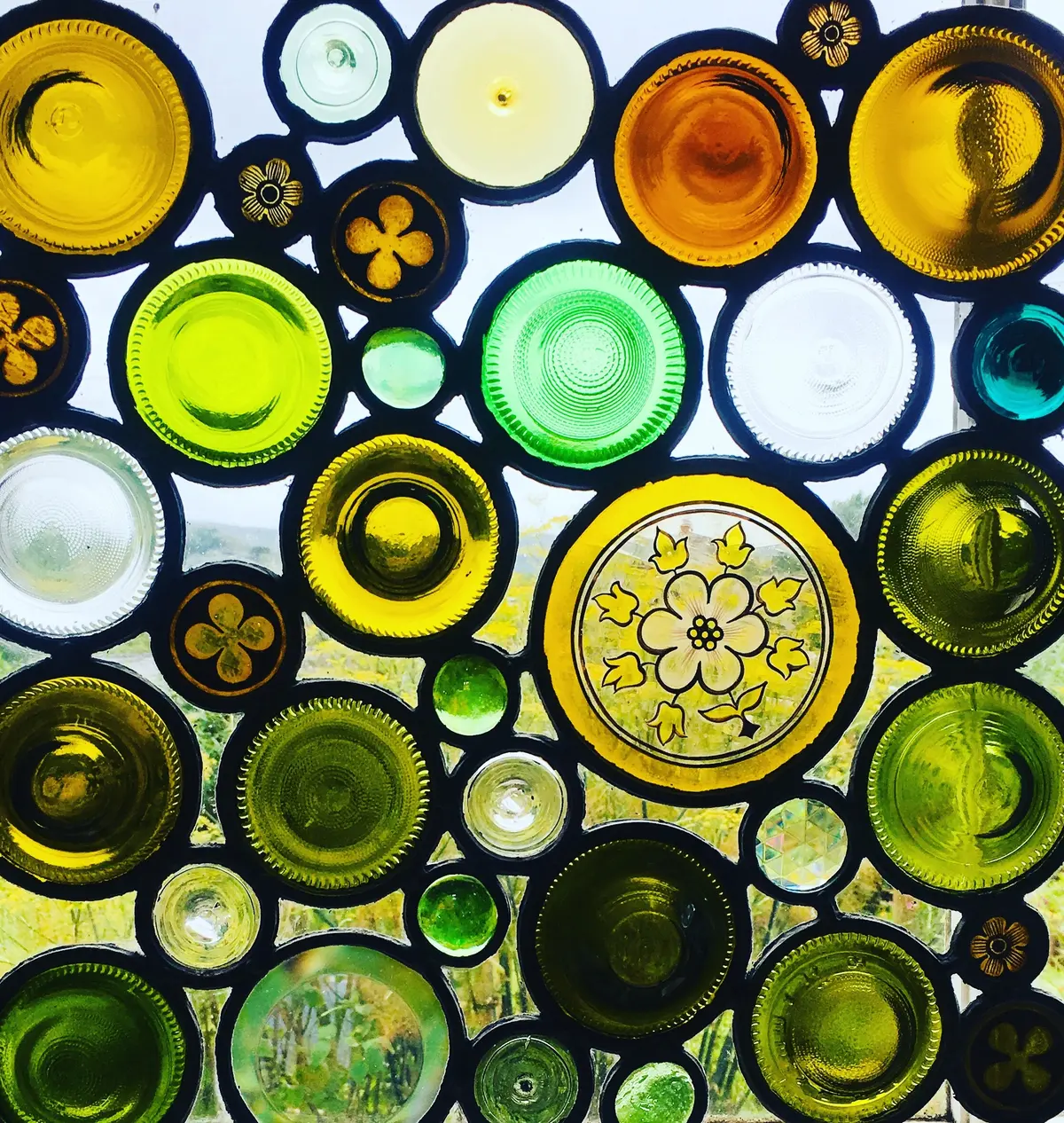 Stained glass window made of reused bottle bases