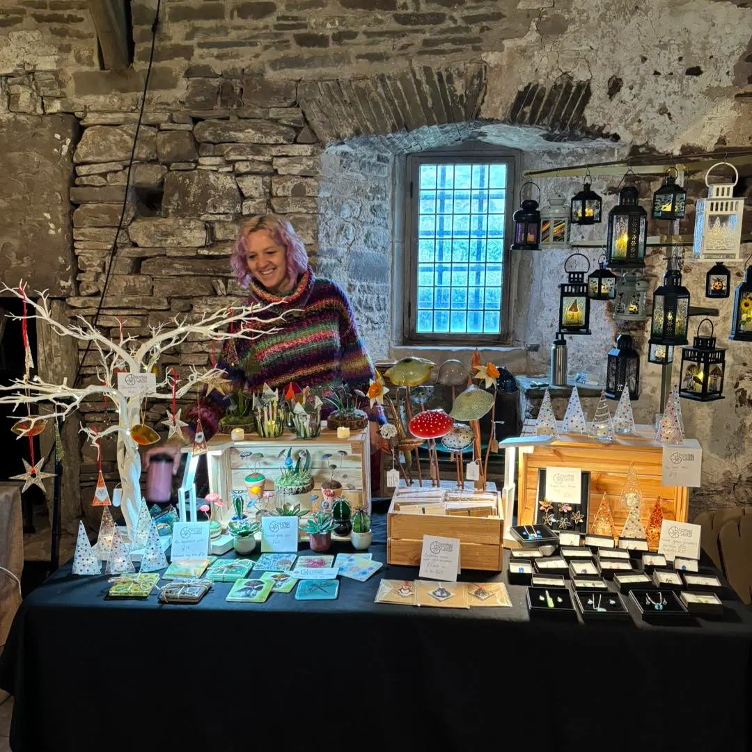 A market stall full of coasters, lanterns and decorative pieces