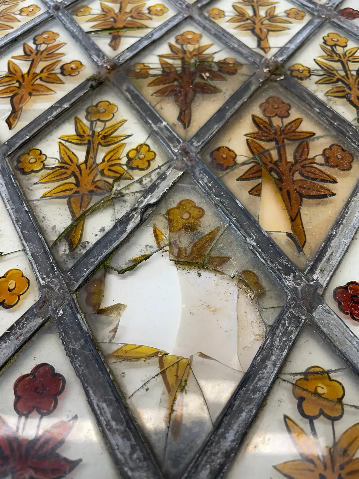 Broken stained glass window being repaired